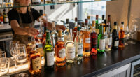 Why Bars Have Mirrors Behind The Liquor (It's More Than Just Appearance)