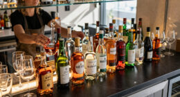 Why Bars Have Mirrors Behind The Liquor (It's More Than Just Appearance)